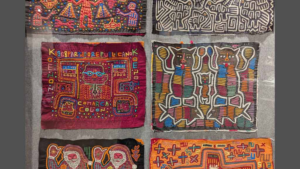 Colorful pieces of fabric with animals, shapes, and text embroidered on them