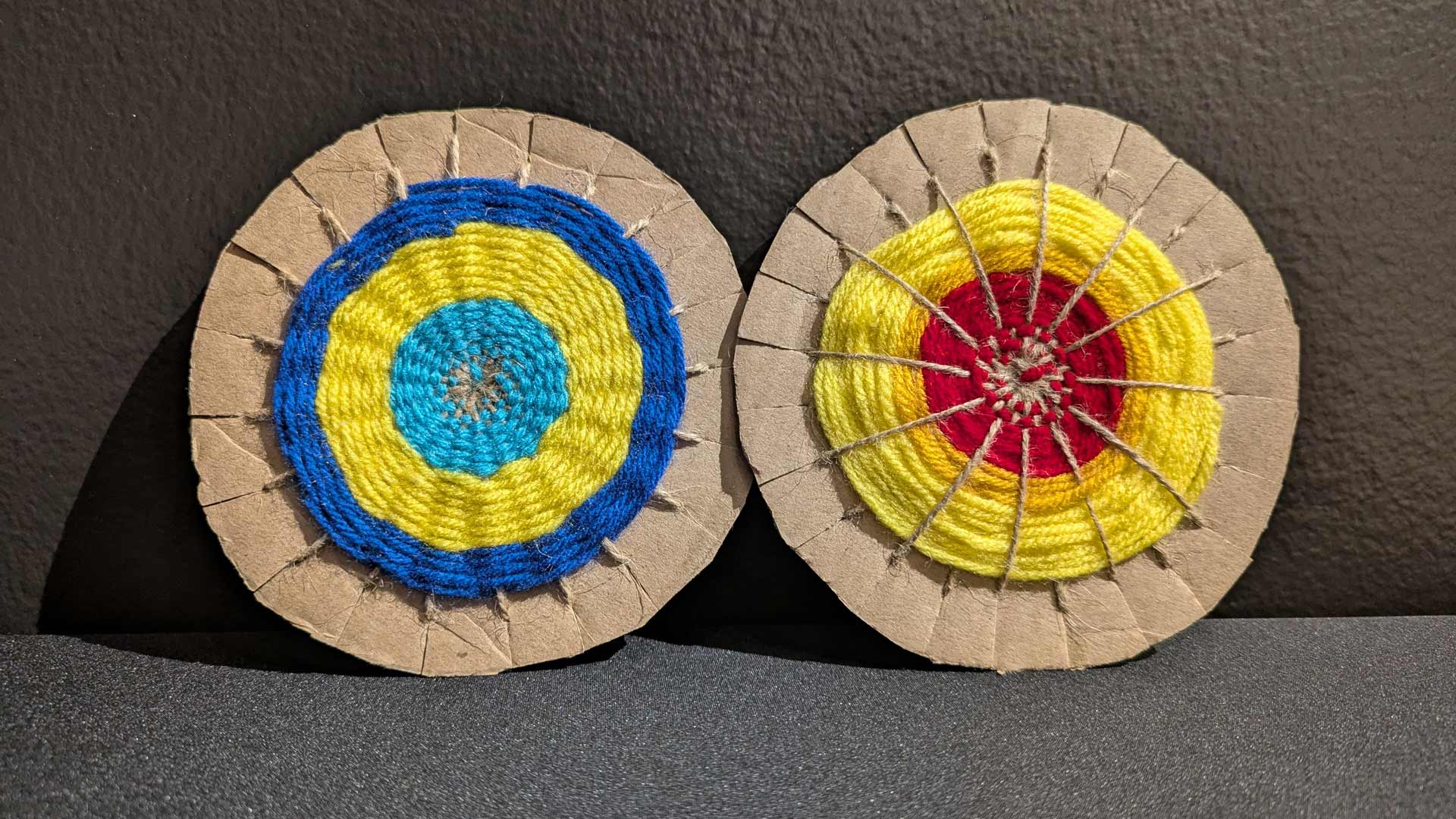Yarn woven into a circular pattern around cardboard