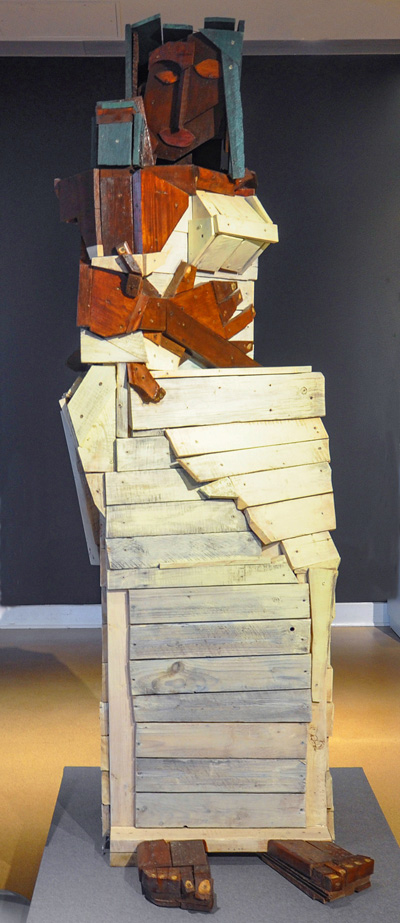 image of the Mother and Child sculpture made of different colored wood pieces