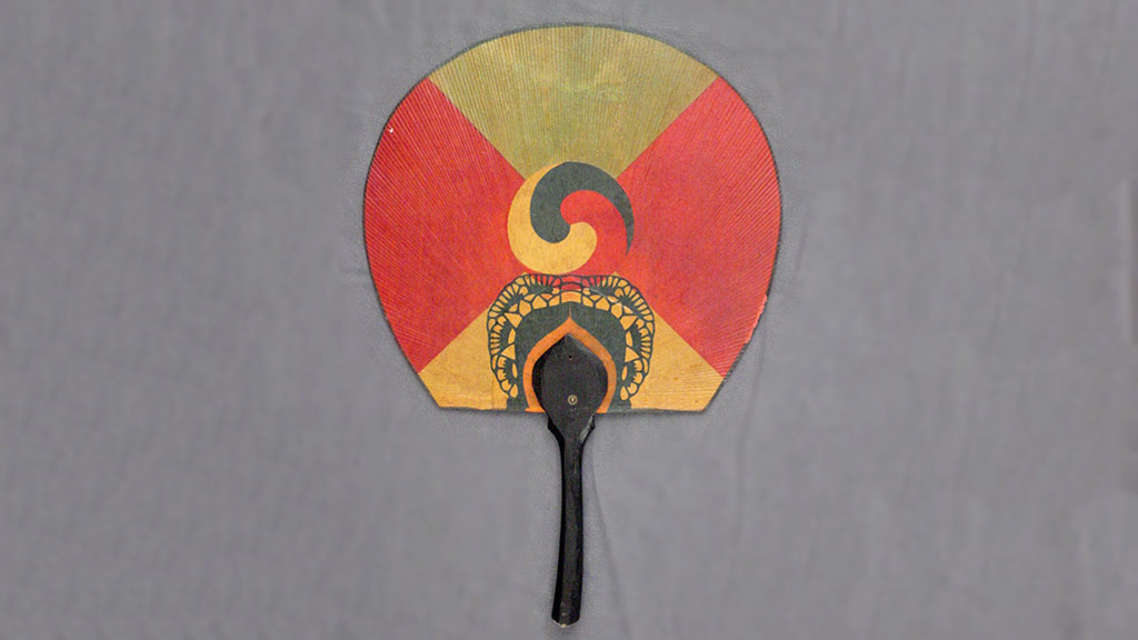 red, green, and gold rigid fan