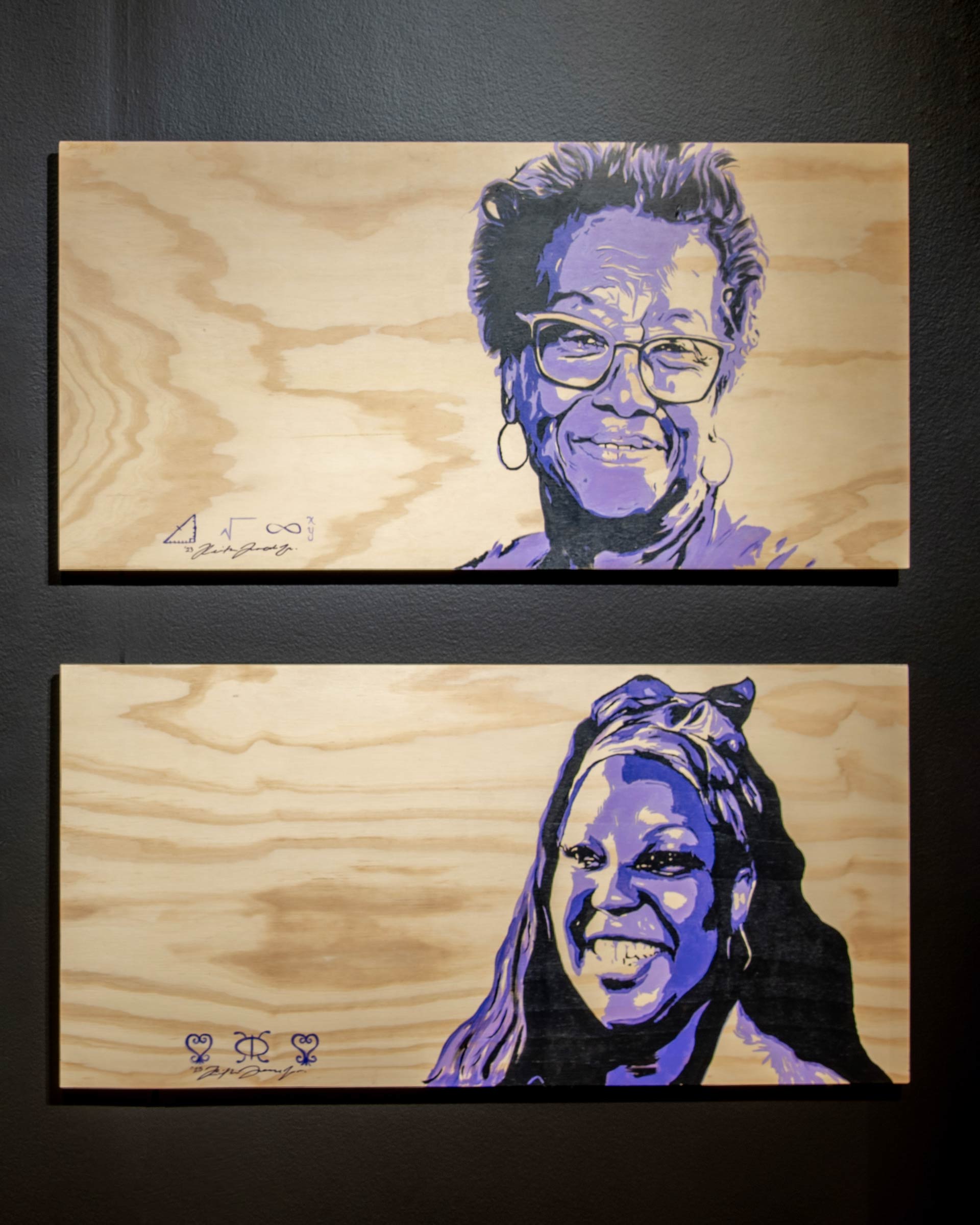 Two wooden canvases with portrais of Black women in three shades of purple