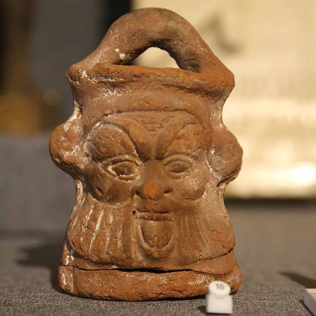 ceramic jug depicting the goddess Bes