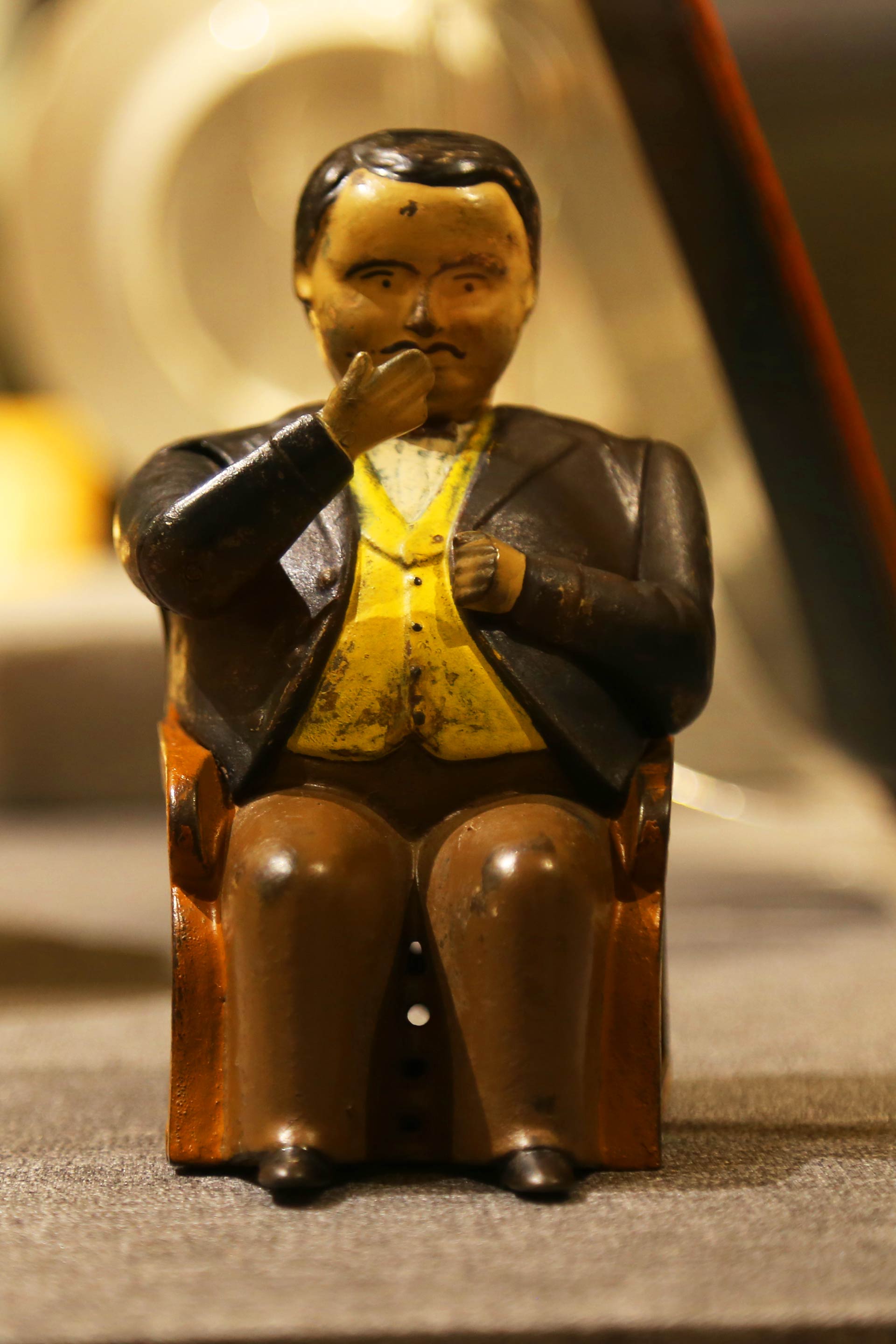 image of a wooden carving of a person sitting on a chair
