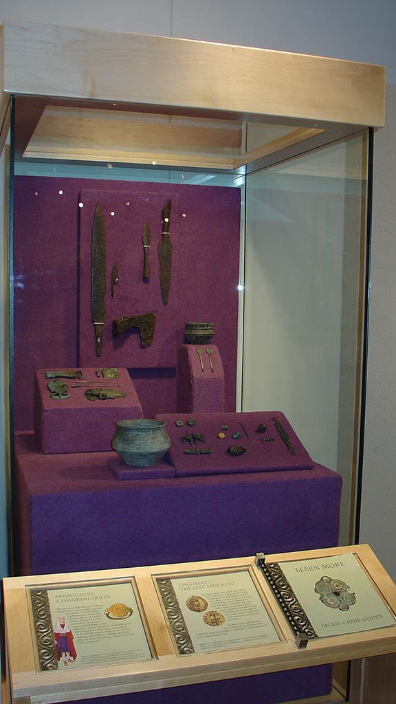 close up display of the same stand and text description about the artifacts inside