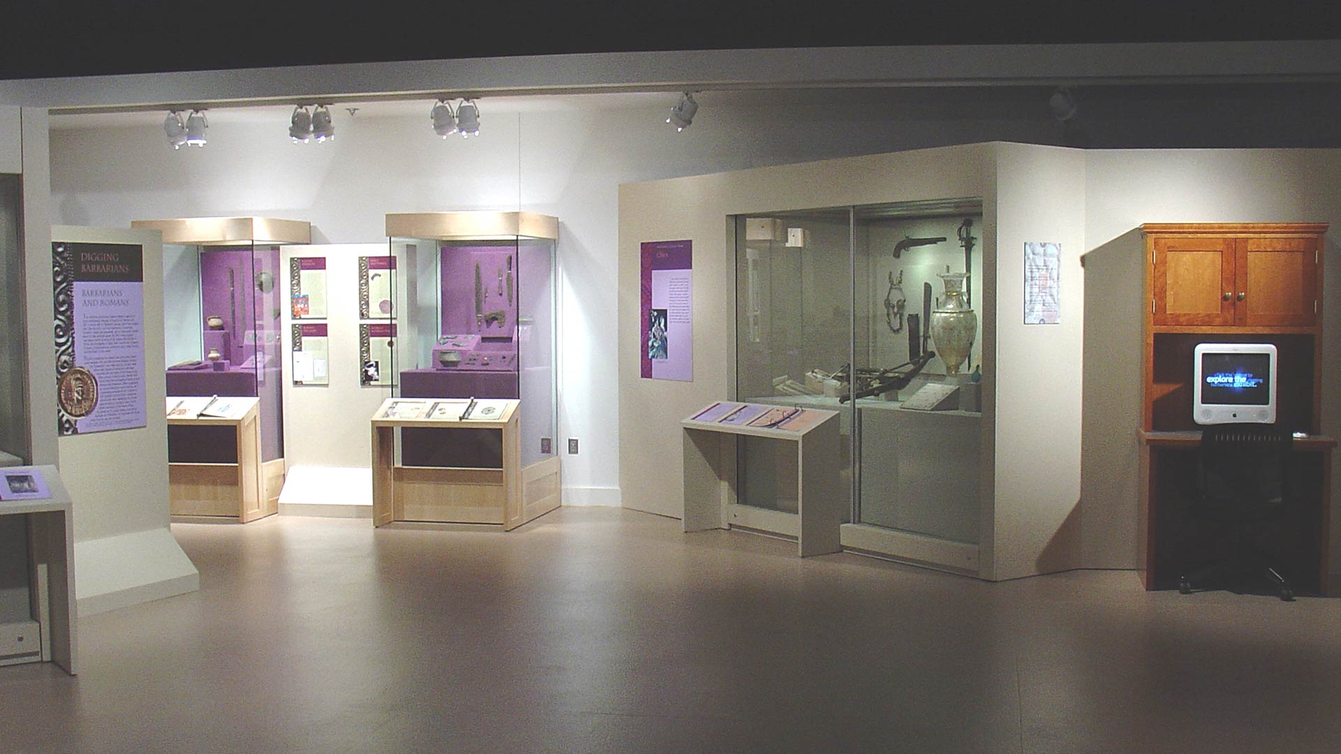 gallery overview, computers, and display cases with various artifacts