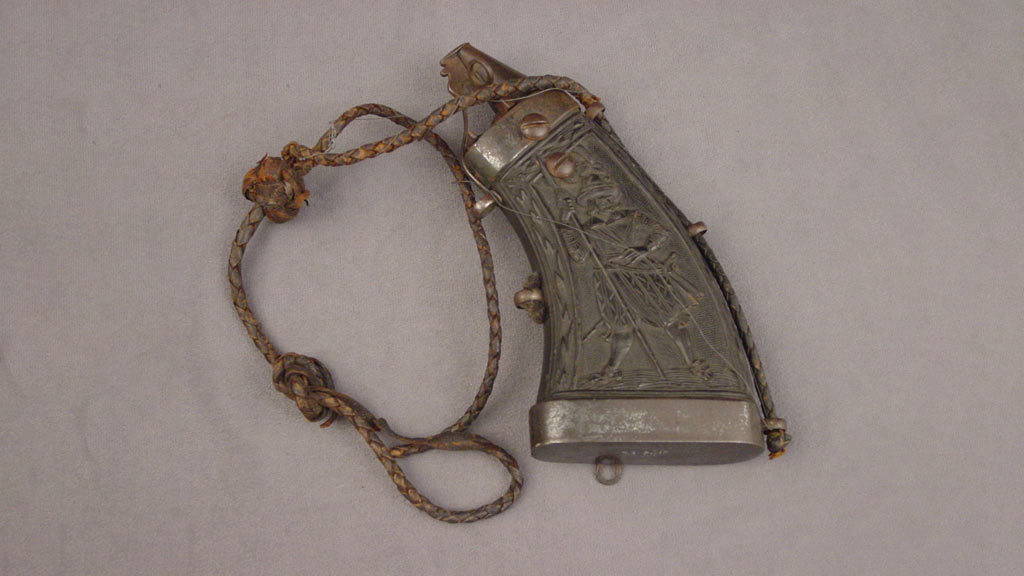 small metal flask with a soldier holding a spear on it