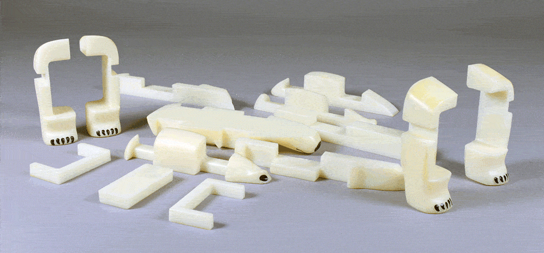 animation of 15 white plastic puzzle pieces assembling into a polar bear figurine