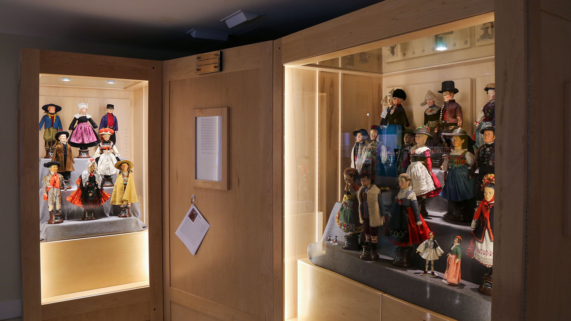 two exhibit cases with approximately 25 dolls with folk costumes