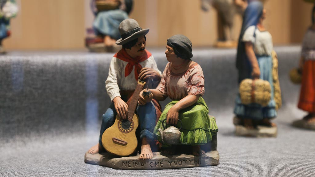 figurine of a man holding a guitar and a woman sitting