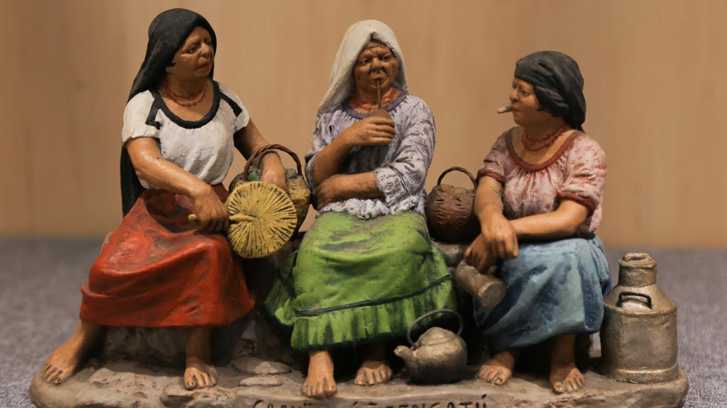figurine of three women sitting next to each other