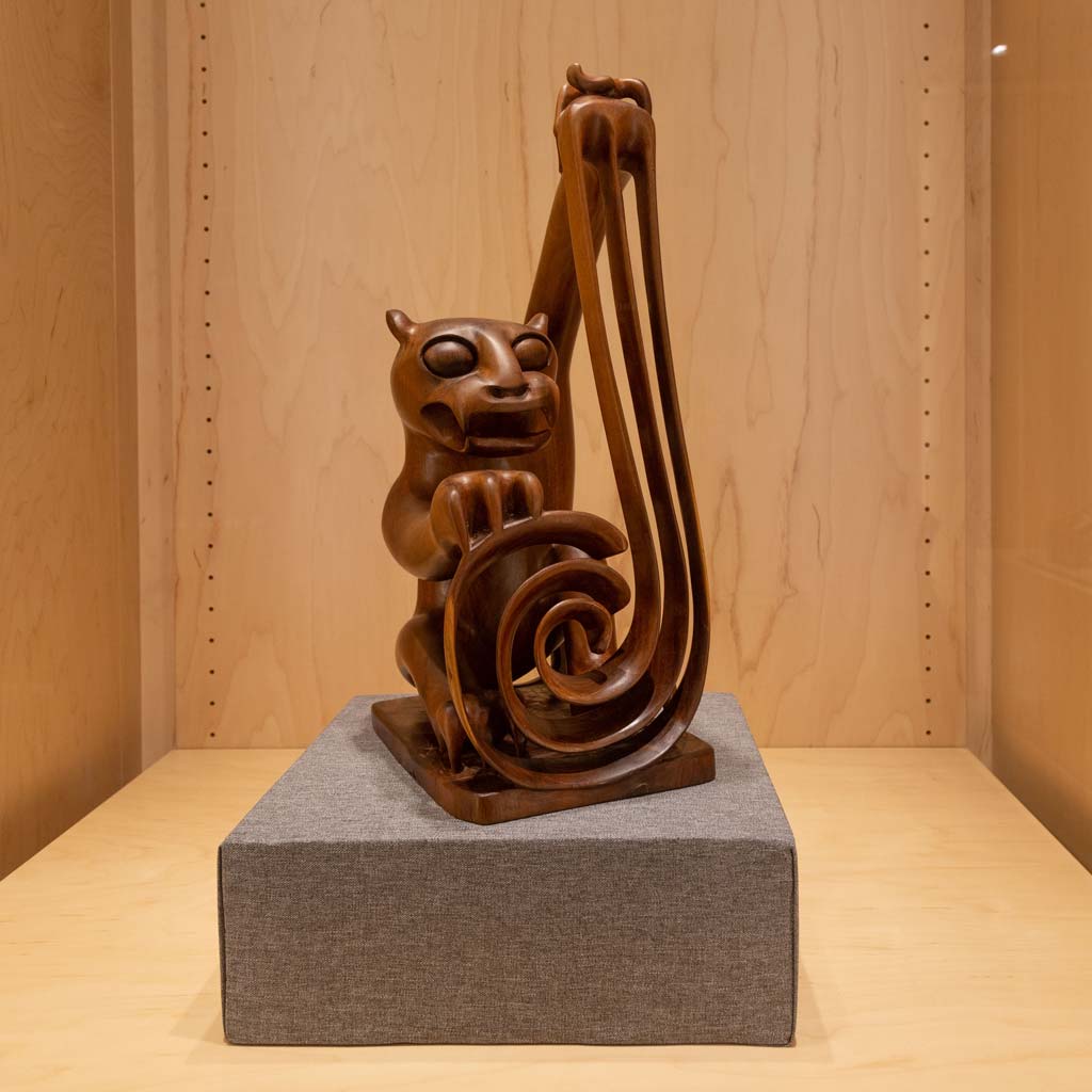 A Mah Meri woodcarving of a tiger holding chains