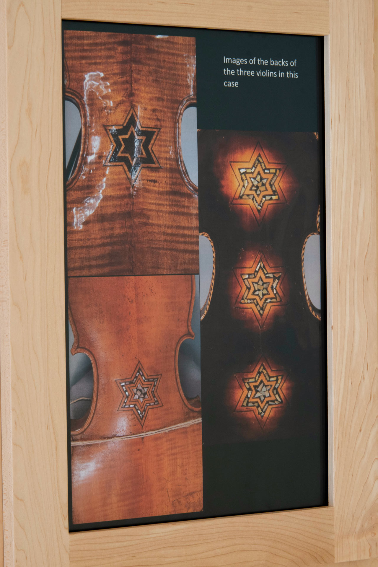 exhibit label with pictures of the backs of the violins on display