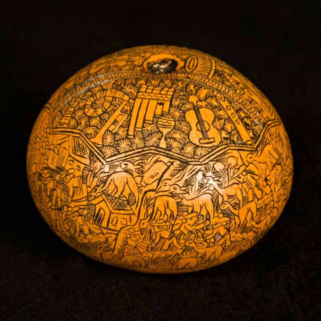 smooth orange round orange object with line art of animals and instruments