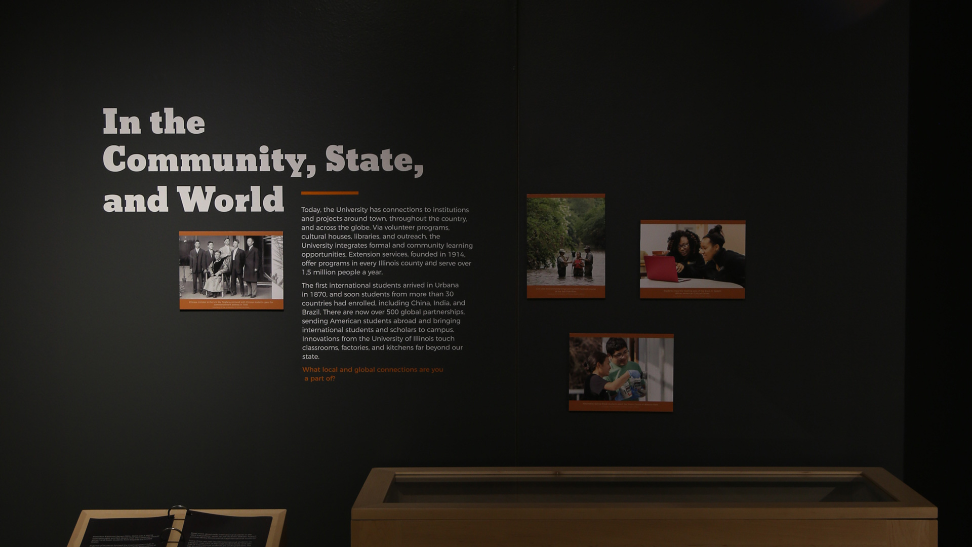 more text and heading text with pictures on a wall, with the heading reading 'in the community, state, and world'