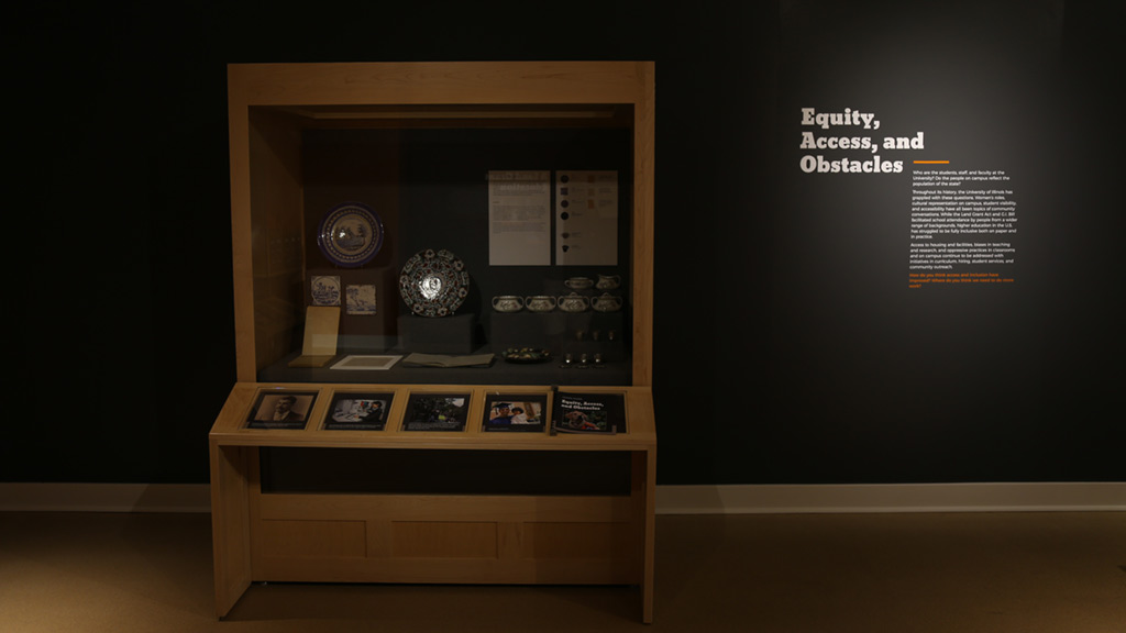 display case with the plates, pots and bowl next to the 'equity, access and obstacles' heading text