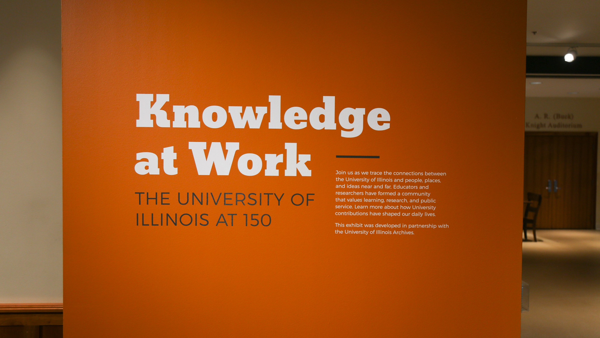 heading text on an orange wall that reads 'knowledge at work'