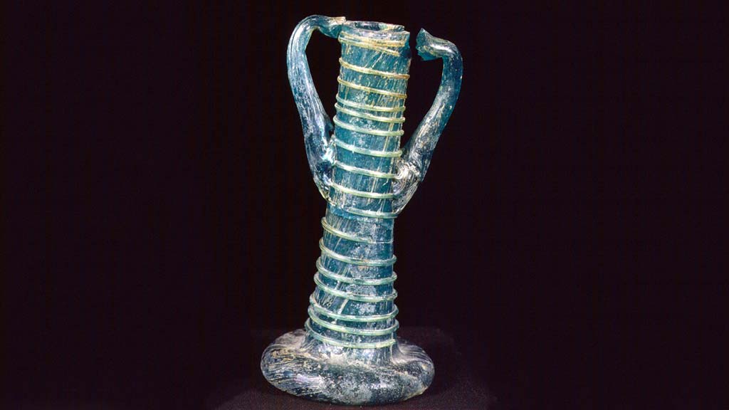 tall and skinny blue glass vessel