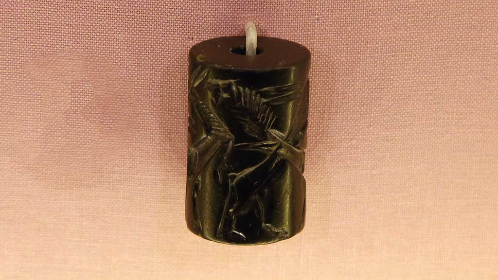 black cylinder seal with animal relief