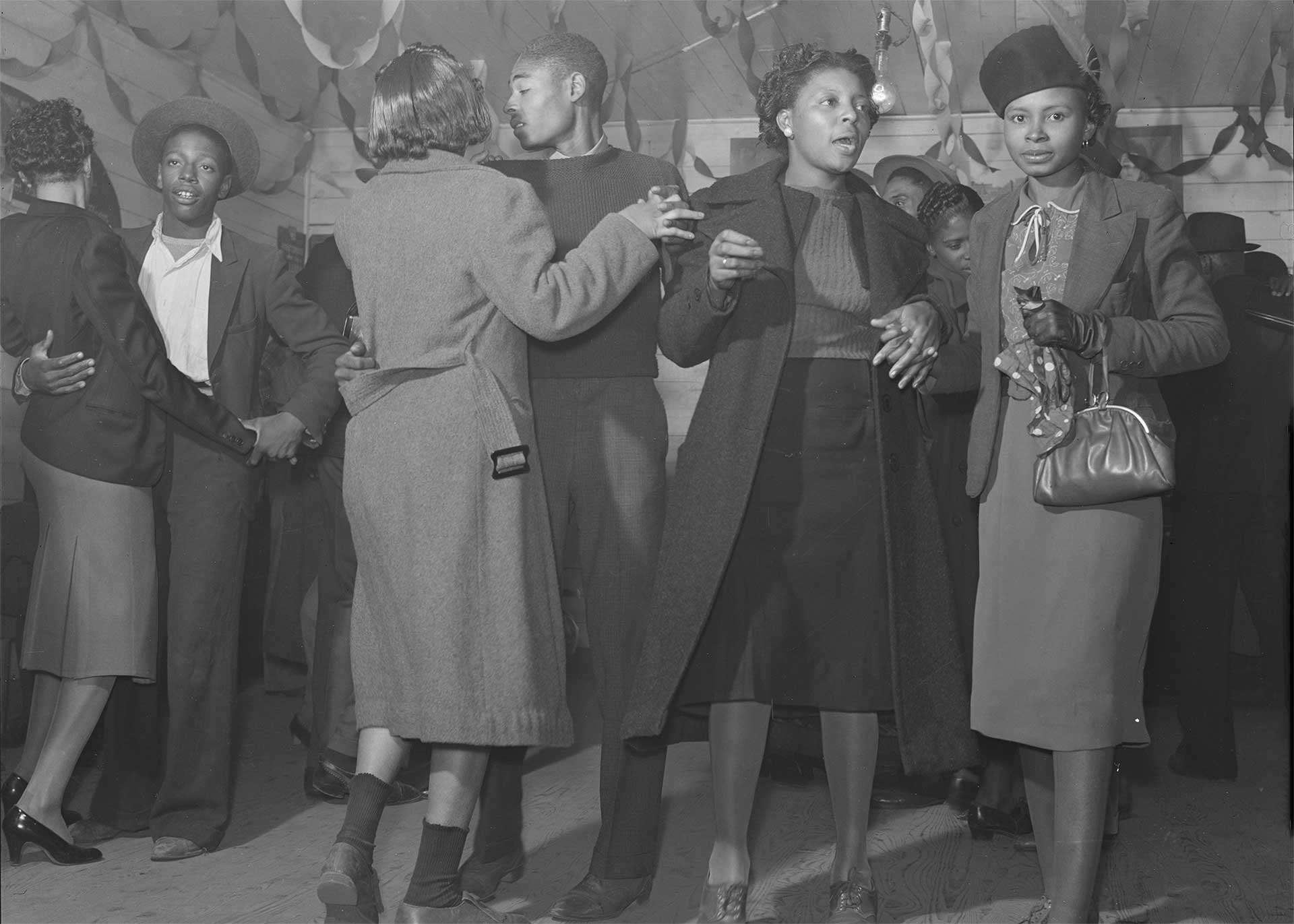 black and white photo of a group of people dancing