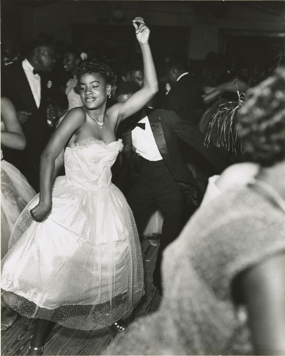 black and white photograph of a woman dancing in a gown