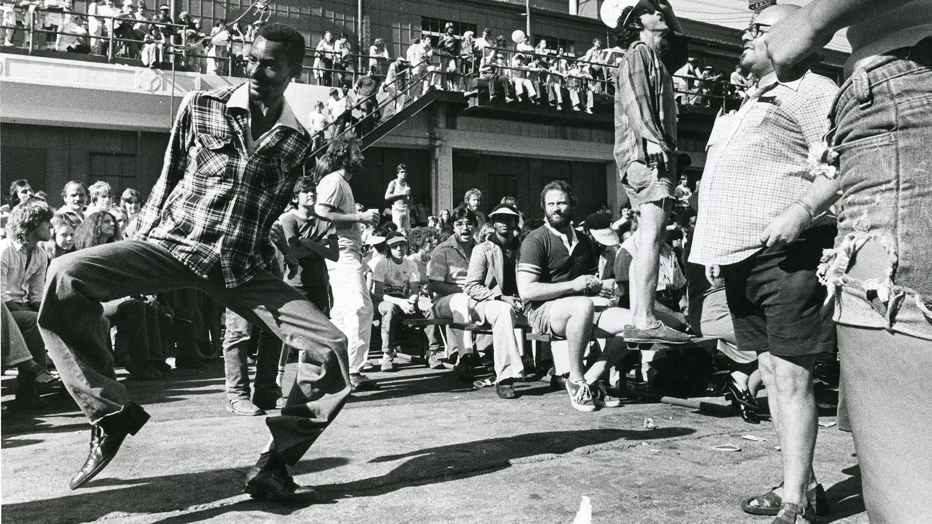 African American man dancing as crowd watches