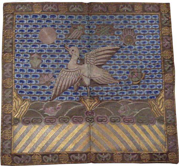 cloth square depicting a bird standing on a rock and surrounded by Buddhist symbols like the infinite knot, wheel of law, lotus