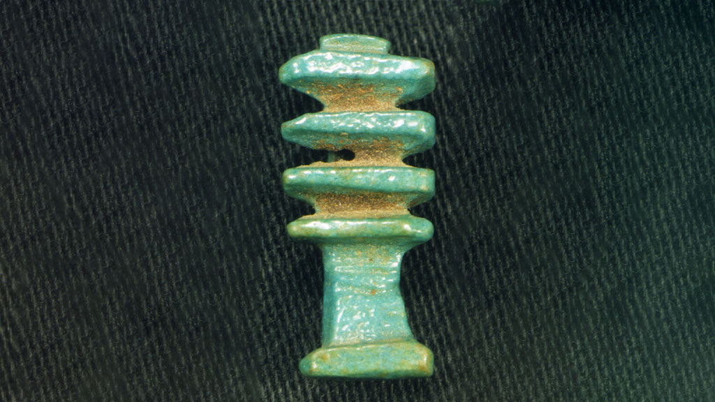 small shiny tower-shaped green amulet