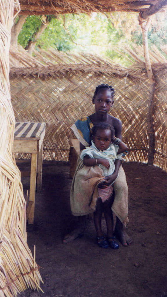 young girl holding a baby