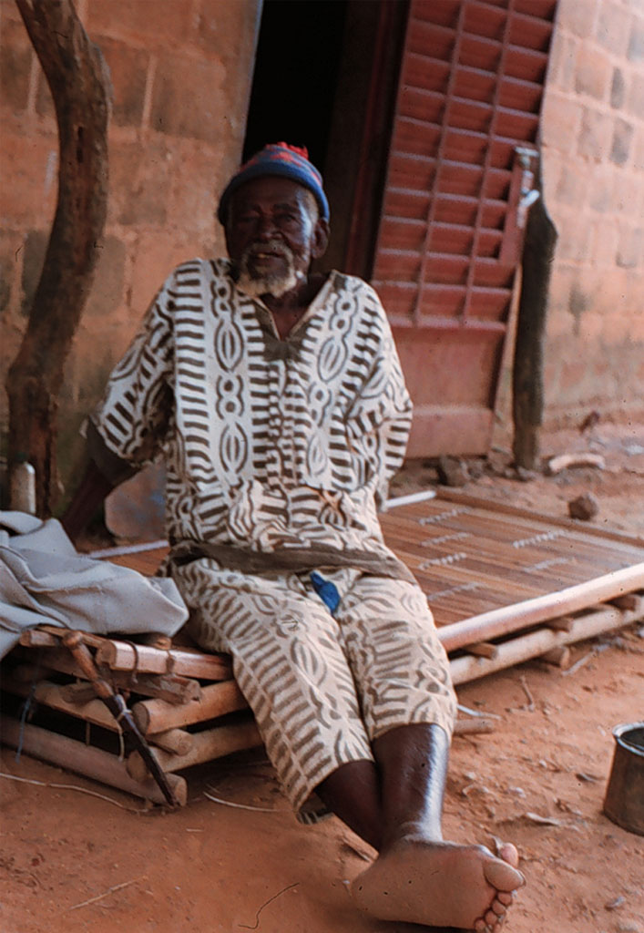 a barefoot man sitting