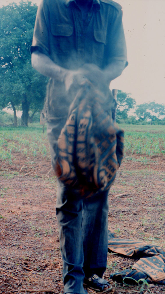 man shaking a cloth