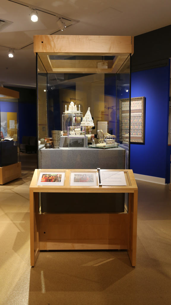 display case with various objects like little figures and little containers