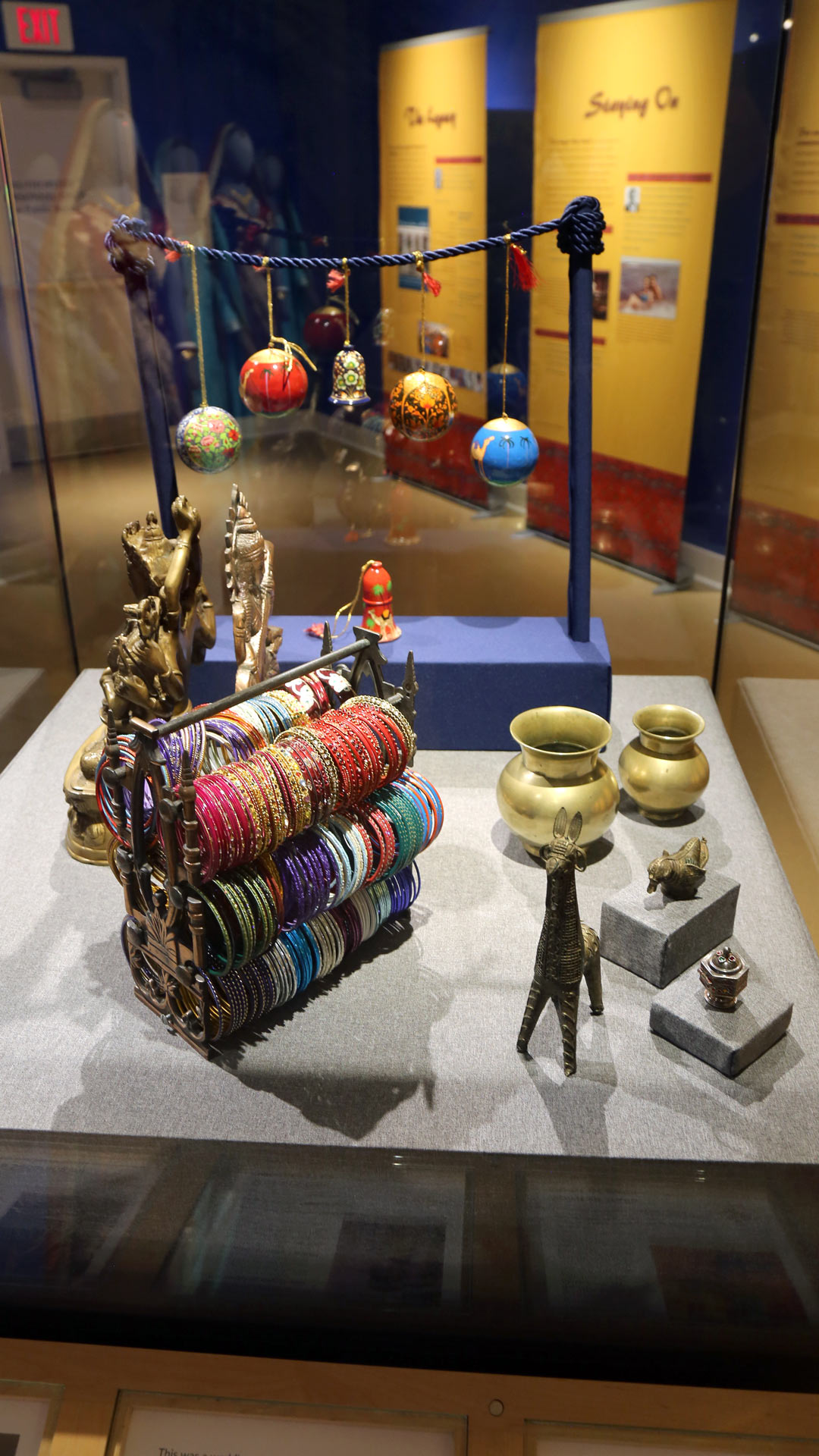 close-up of more jewelry bands and small sculptures of animals and pots