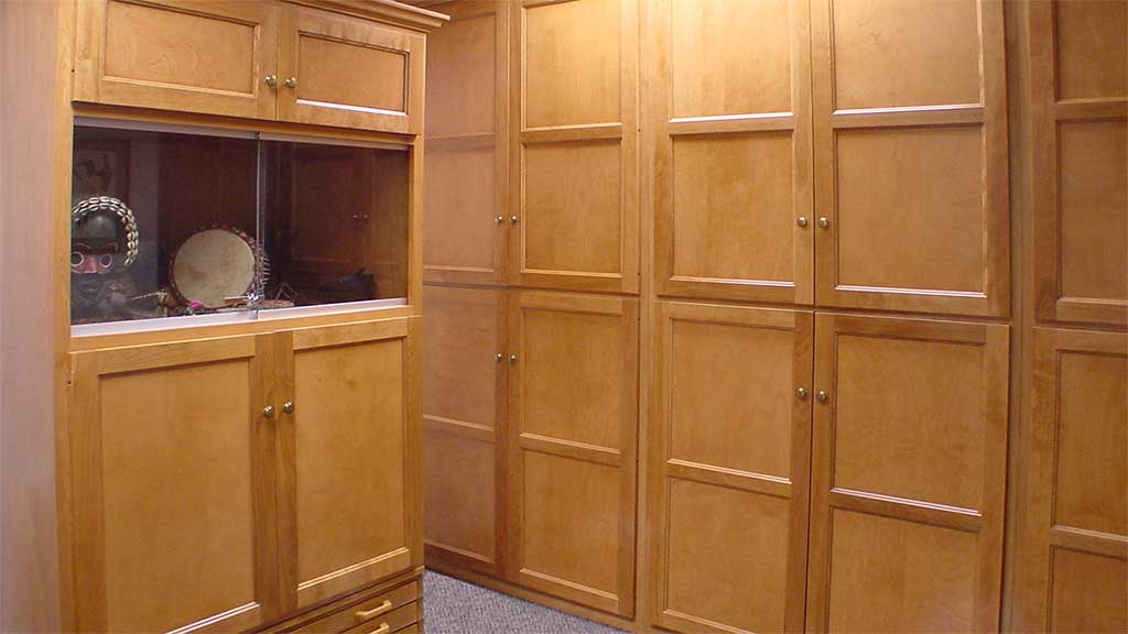 wall of closed cabinets and shelves containing educational materials